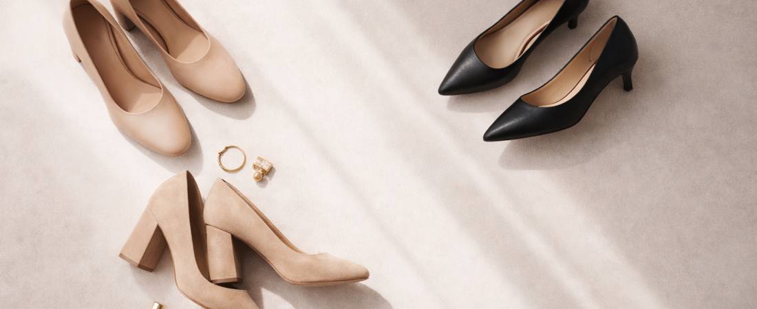 Full‑width elegant flat lay of three pairs of women’s heels—nude block heels, black kitten heels, and beige platform heels—arranged on a cream minimalist background with soft natural lighting, open magazine accent, and subtle Solewell.store logo in the bottom right corner.